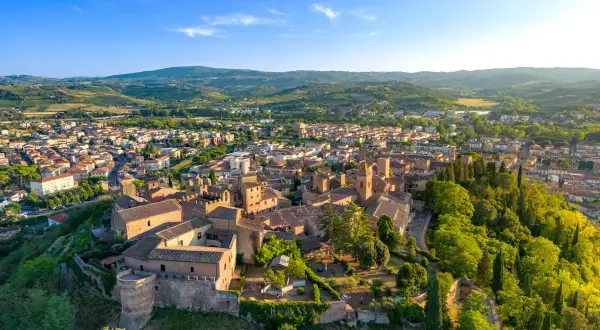 Vista aerea di Certaldo, con il borgo medievale in primo piano e il paese che si estende tra le colline toscane. Il mercato di Certaldo è un'attrazione da non perdere.
