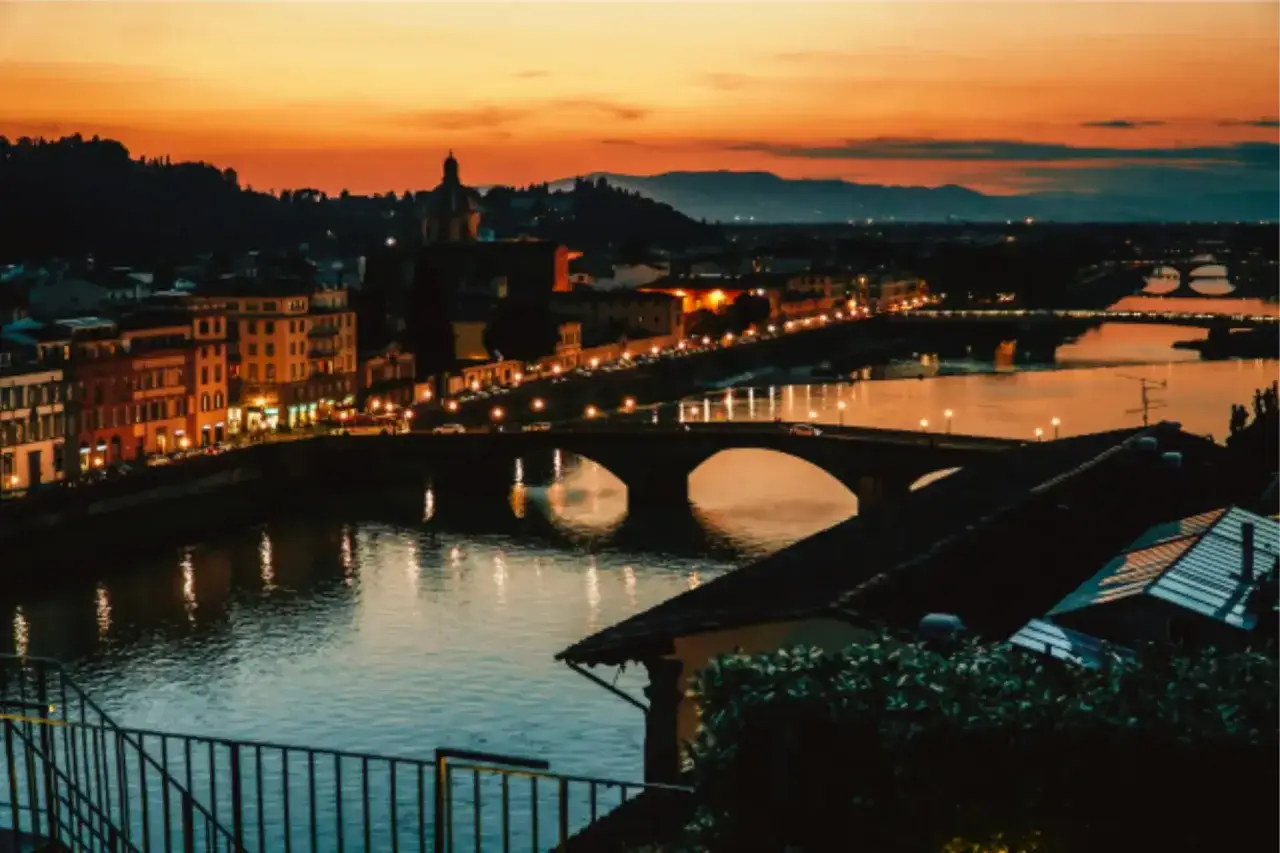 Tramonto su Firenze, con il fiume Arno e il famoso Ponte Vecchio illuminato.