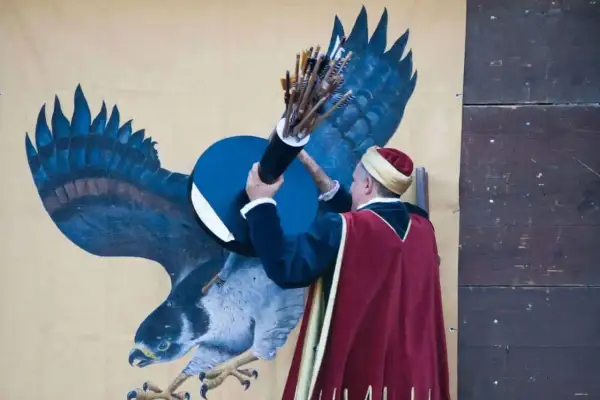 Uomo in abiti storici con faretra piena di frecce, pronto a colpire il bersaglio del balestro del girifalco.